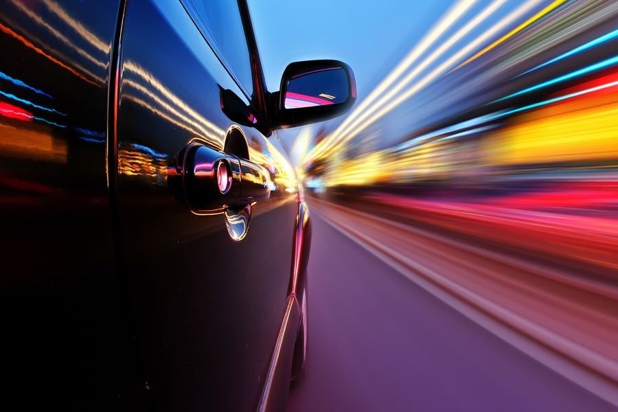 Car on road and streaks of lights